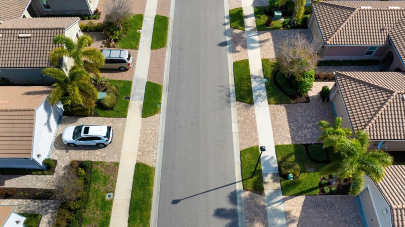 Aerial view of large suburban homes with wide driveways and quiet streets